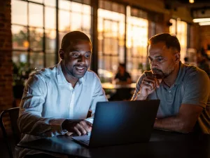 Kabyware consultant reviewing a digital strategy project with a local business owner in a Gilbert coffee shop.
